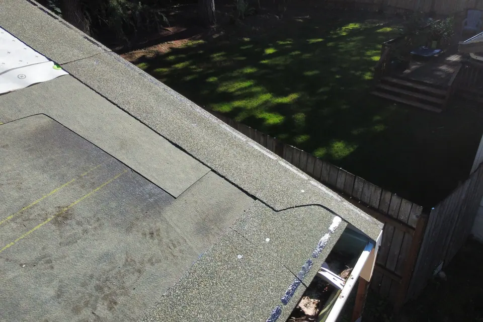 A low-slope roof section in Lake Tapps with granulated cap sheet and new edge metal